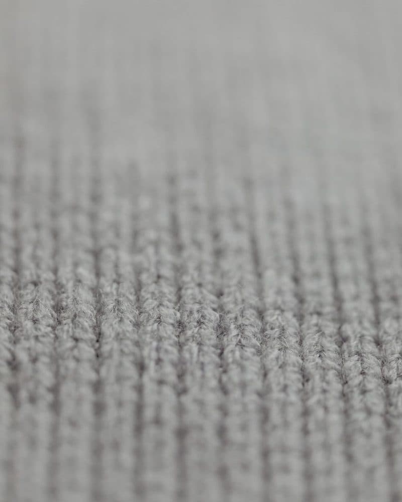 Close-up of a ribbed grey knit fabric texture